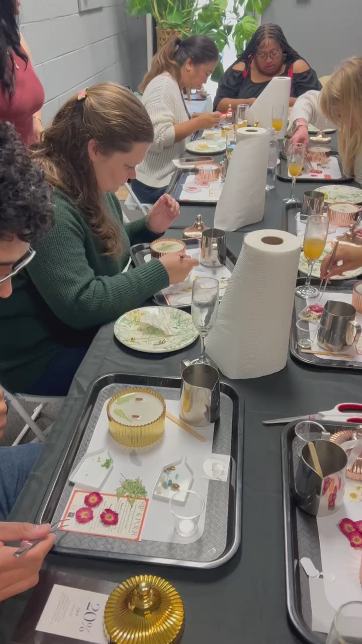 Load video: Le Blanc candle-making class experience with guests pouring candles.